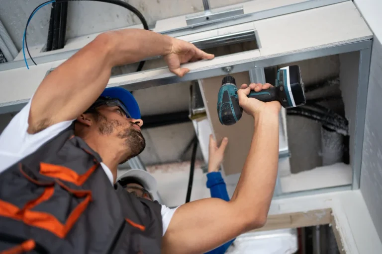 low-angle-people-working-with-drill-scaled